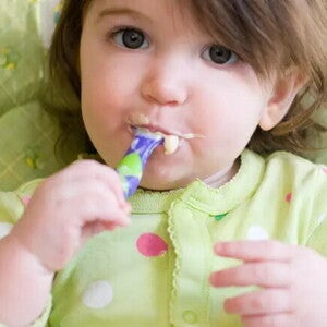Niña comiendo con cubiertos
