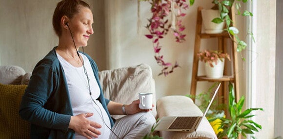 Escucha música o mira una película para facilitar la dilatación. Mamá escuchando música para acelerar la dilatación.
